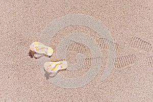 Shoe prints of flip flops at the beach