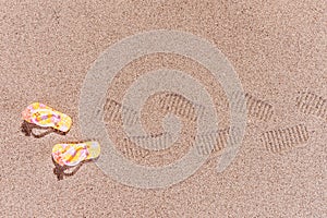 Shoe prints of flip flops at the beach