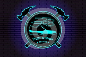 Shoe repair service. Neon symbol in old retro style. On background of brick illuminated wall