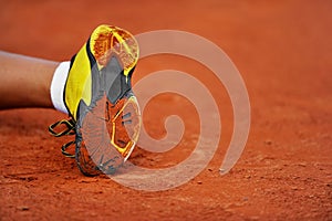 Shoe sole on a tennis clay court