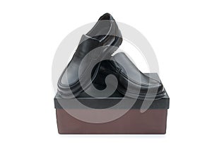 Shoebox and black leather shoes photo