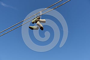 Shoefiti Old shoes hanging on electric cables