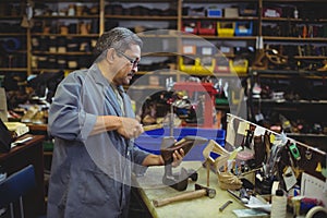 Shoemaker hammering on a shoe