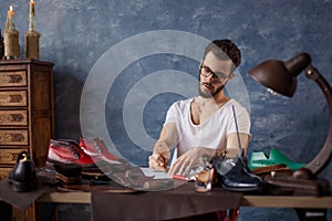 Shoemaker writing alist of necessary tools