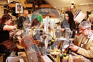 Shoemakers working in a busy workshop