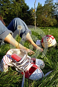 Shoes and bare feet on grass