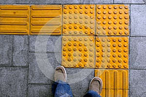 Shoes on block tactile paving for blind handicap