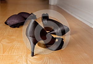 Shoes and bra on bedroom floor