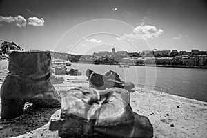 The Shoes on the Danube Bank. Monument - the shoes of the victims of the war in Budapest, Hungary. Danube River and town in the ba