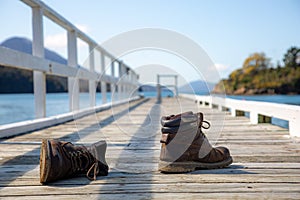 Shoes on the dock near the water.