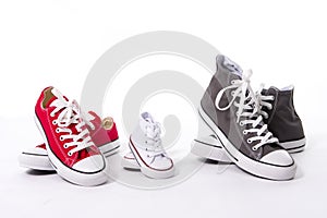 Shoes in father big, mother medium and son or daughter small kid size in family love concept