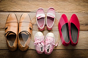 Shoes, four pairs of dad, mom, daughter and son - the family concept.