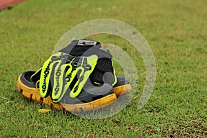 Shoes and gloves football in green grass.