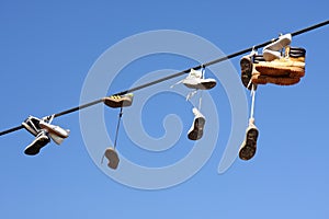 Shoes hanging on cable