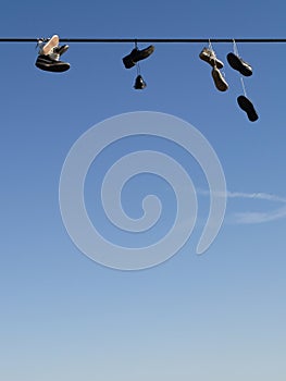 Shoes hanging on a cable