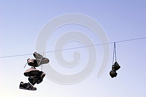 Shoes hanging on a cable