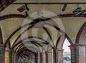 Shoes hanging from the ceiling inside the OberbaumbrÃ¼cke bridge in Berlin, Germany