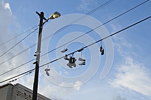 Shoes hanging from the wires off the building