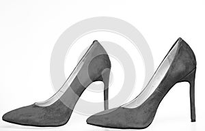 Shoes made out of red suede on white background, isolated. Pair of fashionable high heeled pump shoes. Footwear for