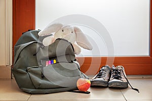 Shoes and School bag with cuddly toy supplies and lunch