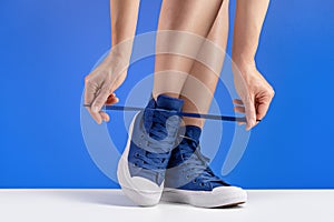 Shoes for sports, blue background. Copy space.