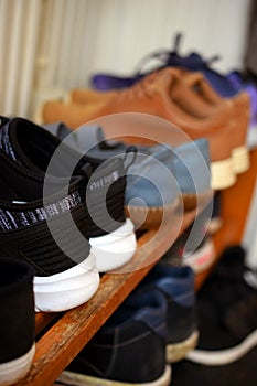 Shoes on wooden shoe rack