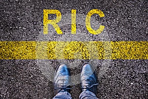 Shoes and word RIC meaning referendum at citizen`s initiative on asphalt