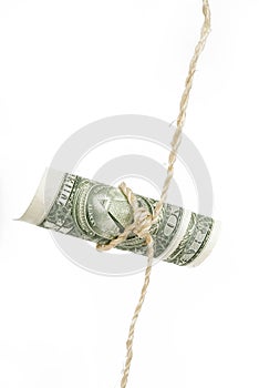 Shoestring budget dollar.  string or twine tied in a bow isolated on white background
