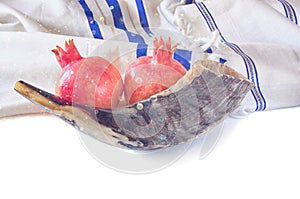 Shofar (horn), white prayer talit and pomegranate isolated on white. rosh hashanah (jewish holiday) concept . traditional holiday