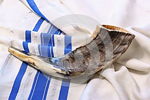 Shofar (horn) on white prayer talit. room for text. rosh hashanah (jewish holiday) concept . traditional holiday symbol.