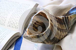 Shofar (horn) on white prayer talit. room for text. rosh hashanah (jewish holiday) concept . traditional holiday symbol.