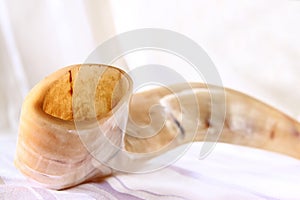 Shofar (horn) on white prayer talit. rosh hashanah (jewish holiday) concept . traditional holiday symbol.