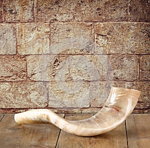 Shofar (horn) on wooden table. rosh hashanah (jewish holiday) concept . traditional holiday symbol.