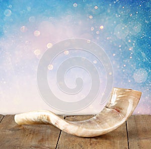 Shofar (horn) on wooden table. rosh hashanah (jewish holiday) concept . traditional holiday symbol.