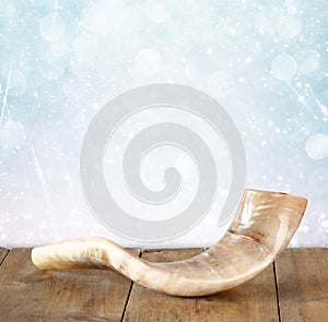 Shofar (horn) on wooden table. rosh hashanah (jewish holiday) concept . traditional holiday symbol.