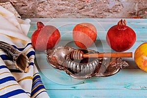 Shofar and tallit with honey jar and fresh ripe apples. Jewish new year Yom Kippur and Rosh Hashanah