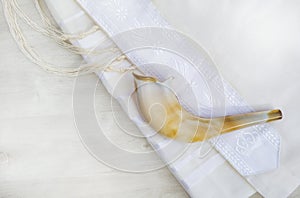 Shofar and tallit on a white background for Rosh Hashanah and Yom Kippur