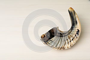 Shofar on white table, space for text. Rosh Hashanah holiday attribute