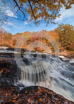 Shohola Falls in the Pennsylvania Poconos on a beautiful fall morning surrounded by peak fall foliage