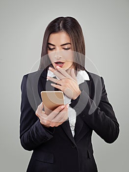 Shoked Woman looking at cell phone photo