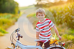 Shool kid boy having fun with riding of bicycle