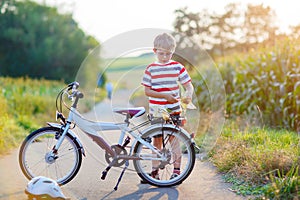 Shool kid boy having fun with riding of bicycle