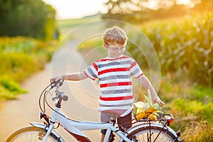 Shool kid boy having fun with riding of bicycle