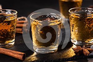 Shoot glass of alcoholic drinks with star anise and cinnamon