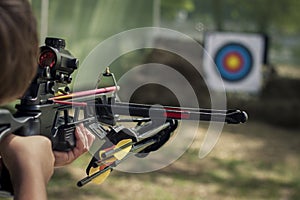 The shooter directed the crossbow towards the colored target photo