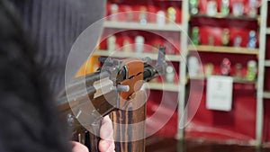 Shooter fires a gun at a target. Shooting gallery