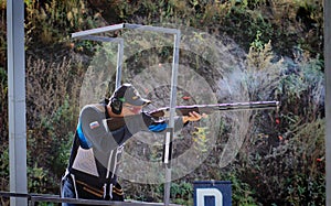 Shooter from a gun practicing shooting on plates in nature