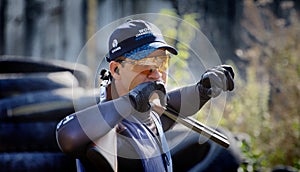 Shooter from a gun practicing shooting on plates in nature