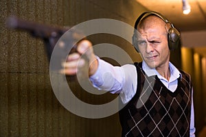 Shooter practicing sport handgun shooting at firing range