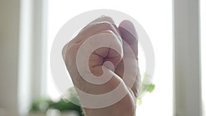 Shooting with an Angry Man Clenching the Fist in Sign of Protest. One Person Getting Mad and Clench the Hand Fingers in a Fist.